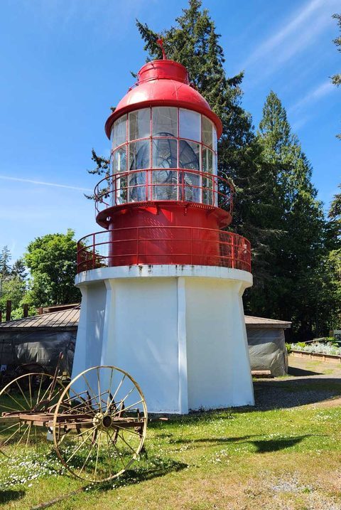 Red-and-white lighthouse display on the grounds of the Sooke Region Museum